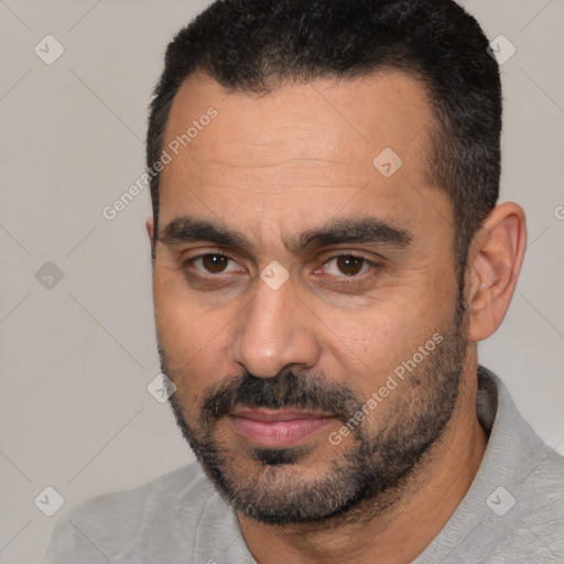 Joyful white adult male with short  black hair and brown eyes