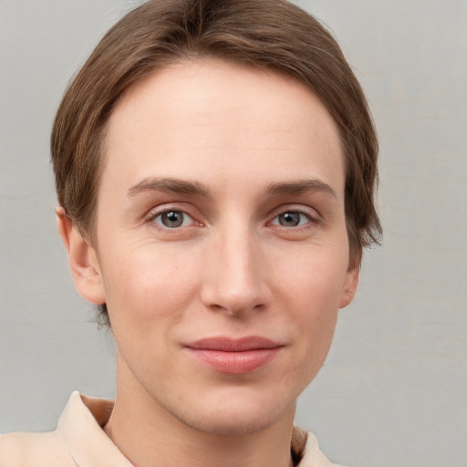 Joyful white young-adult female with short  brown hair and grey eyes