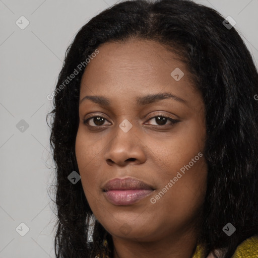 Joyful black young-adult female with long  black hair and brown eyes