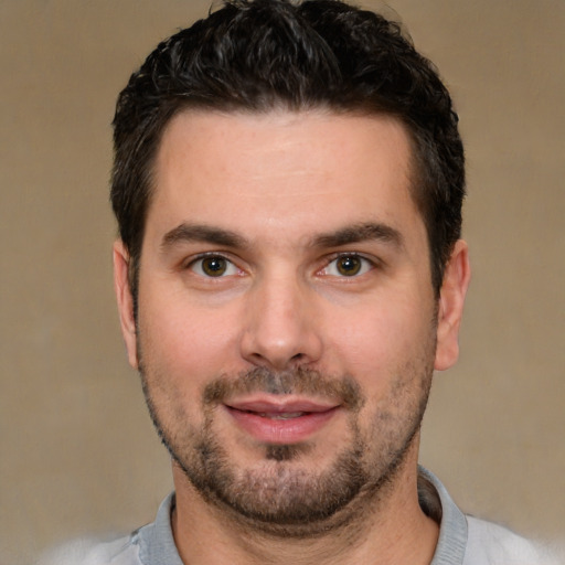 Joyful white young-adult male with short  black hair and brown eyes