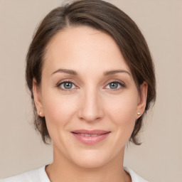 Joyful white young-adult female with medium  brown hair and grey eyes