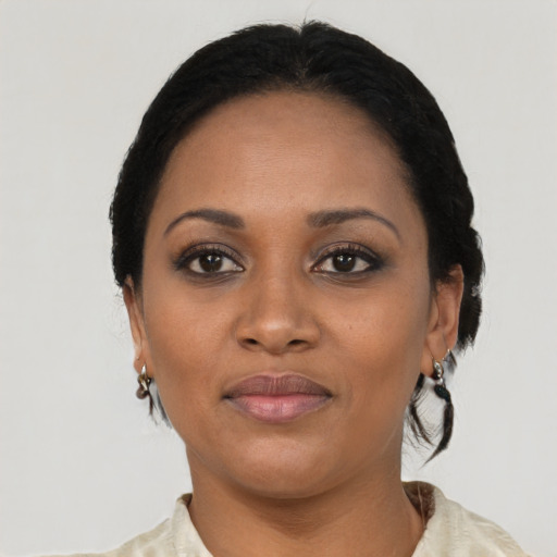 Joyful black adult female with short  black hair and brown eyes