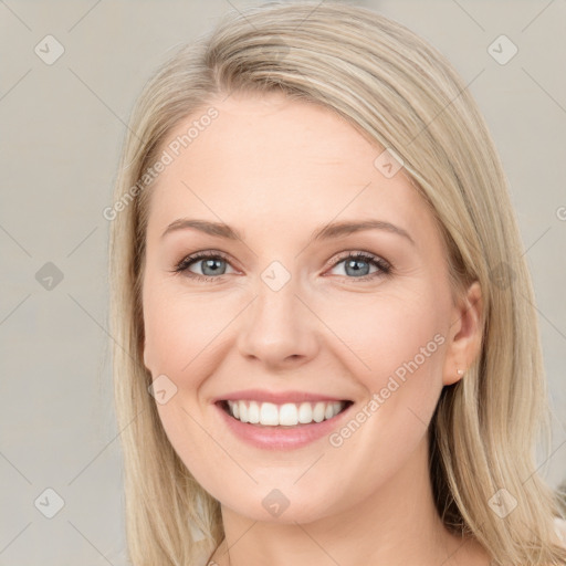 Joyful white young-adult female with long  brown hair and blue eyes