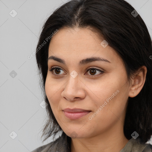 Joyful latino young-adult female with long  brown hair and brown eyes