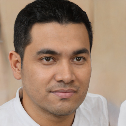 Joyful latino young-adult male with short  brown hair and brown eyes