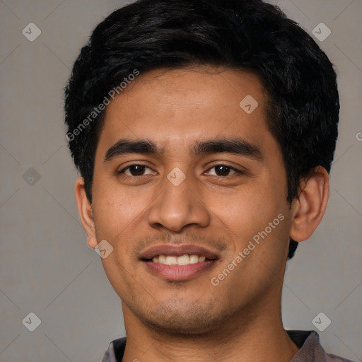 Joyful latino young-adult male with short  black hair and brown eyes