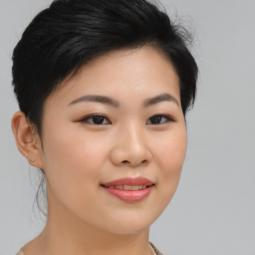 Joyful asian young-adult female with medium  black hair and brown eyes