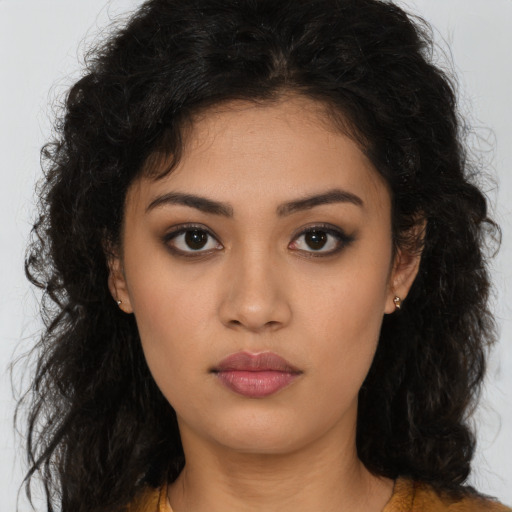 Neutral latino young-adult female with long  brown hair and brown eyes