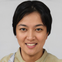 Joyful asian young-adult female with short  black hair and brown eyes