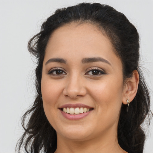 Joyful latino young-adult female with long  brown hair and brown eyes