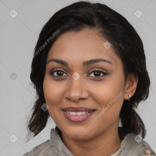 Joyful black young-adult female with medium  black hair and brown eyes