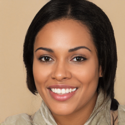 Joyful latino young-adult female with long  black hair and brown eyes