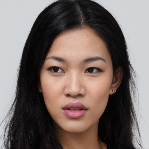 Joyful asian young-adult female with long  black hair and brown eyes