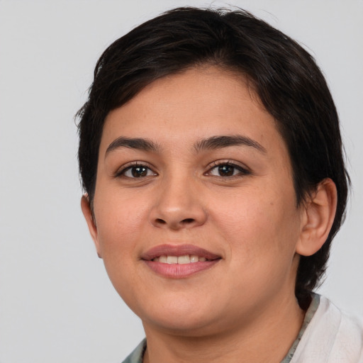 Joyful white young-adult female with short  brown hair and brown eyes