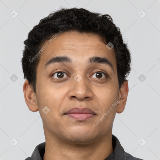 Joyful latino young-adult male with short  brown hair and brown eyes