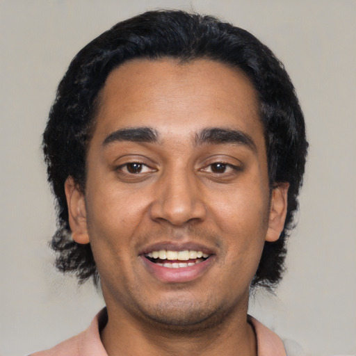 Joyful black young-adult male with short  black hair and brown eyes