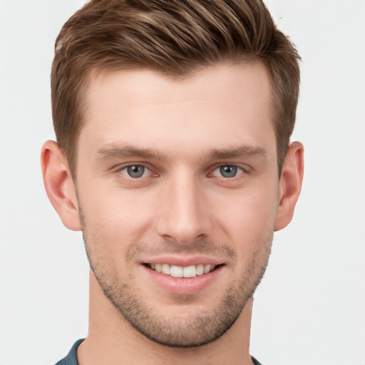 Joyful white young-adult male with short  brown hair and grey eyes