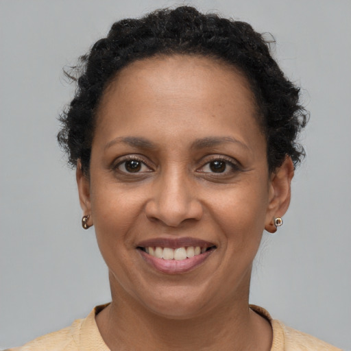 Joyful black adult female with short  brown hair and brown eyes