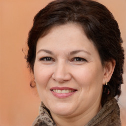 Joyful white adult female with medium  brown hair and brown eyes