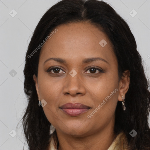 Joyful black adult female with long  brown hair and brown eyes