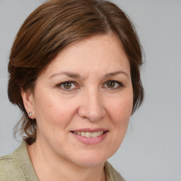 Joyful white adult female with medium  brown hair and grey eyes