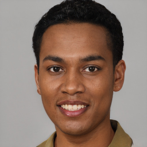 Joyful black young-adult male with short  black hair and brown eyes
