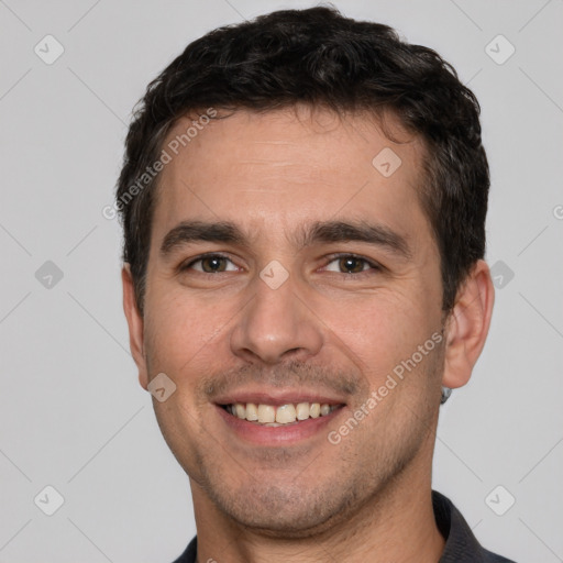 Joyful white young-adult male with short  black hair and brown eyes