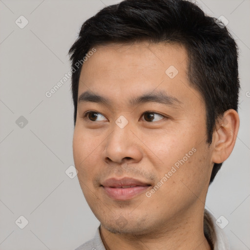 Joyful asian young-adult male with short  black hair and brown eyes