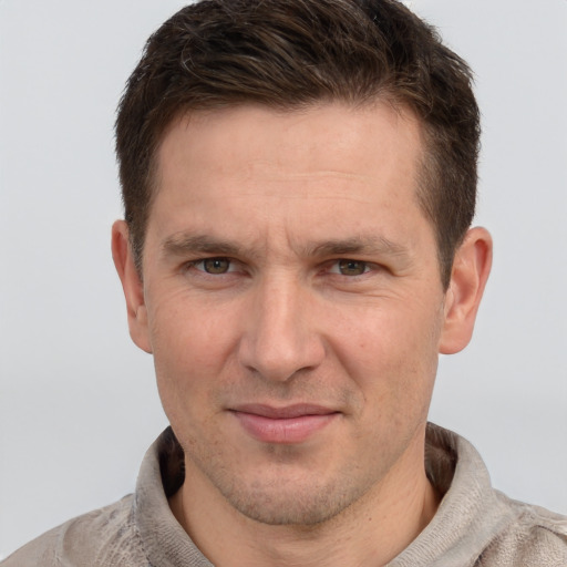 Joyful white adult male with short  brown hair and grey eyes