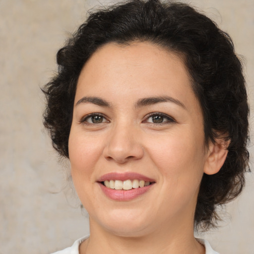 Joyful latino young-adult female with medium  brown hair and brown eyes