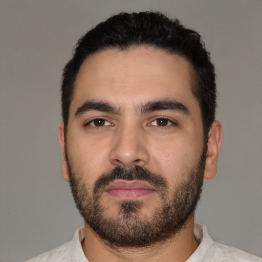 Neutral latino young-adult male with short  black hair and brown eyes