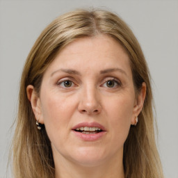 Joyful white adult female with long  brown hair and grey eyes