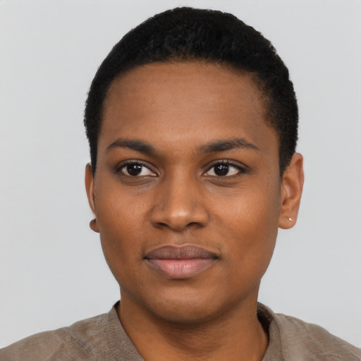 Joyful black young-adult female with short  black hair and brown eyes