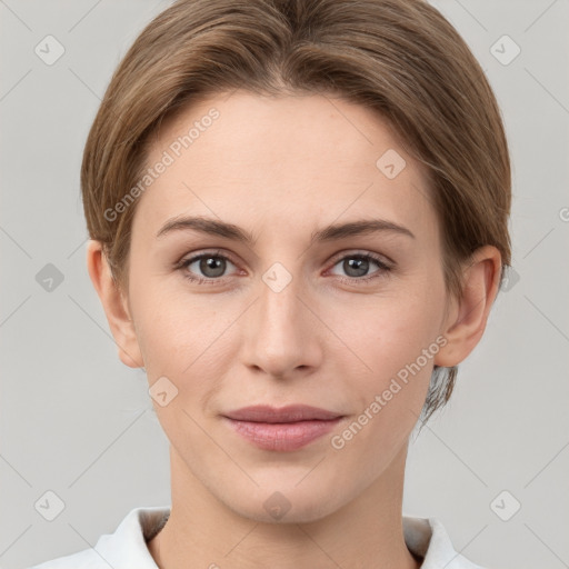 Joyful white young-adult female with short  brown hair and grey eyes