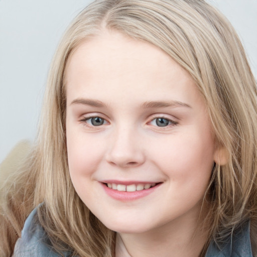 Joyful white child female with long  brown hair and blue eyes