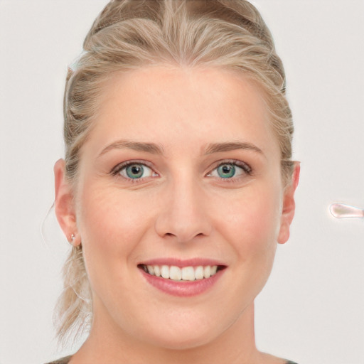 Joyful white young-adult female with long  blond hair and blue eyes