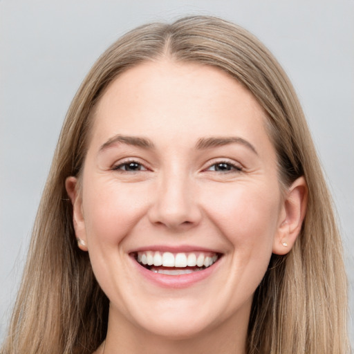 Joyful white young-adult female with long  brown hair and grey eyes