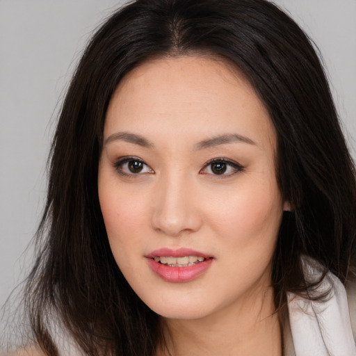 Joyful asian young-adult female with long  brown hair and brown eyes