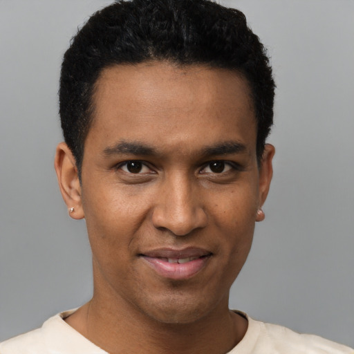 Joyful black young-adult male with short  black hair and brown eyes