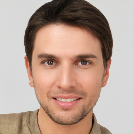 Joyful white young-adult male with short  brown hair and brown eyes