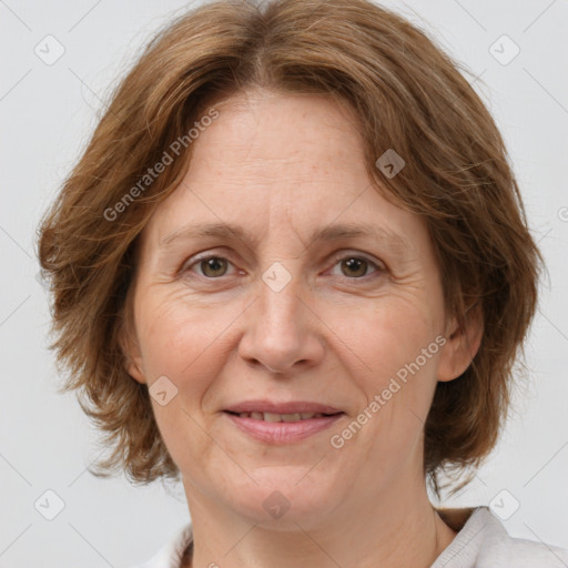 Joyful white adult female with medium  brown hair and green eyes