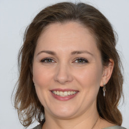 Joyful white adult female with medium  brown hair and brown eyes