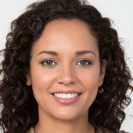 Joyful white young-adult female with long  brown hair and brown eyes