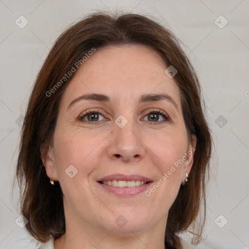 Joyful white adult female with medium  brown hair and grey eyes