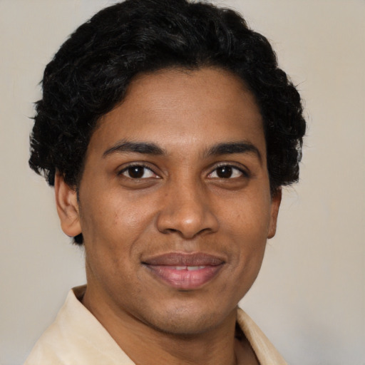 Joyful latino adult male with short  brown hair and brown eyes