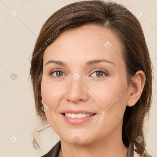 Joyful white young-adult female with medium  brown hair and grey eyes