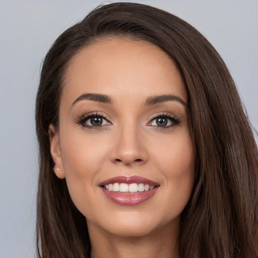 Joyful white young-adult female with long  brown hair and brown eyes