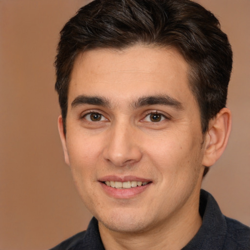 Joyful white young-adult male with short  brown hair and brown eyes