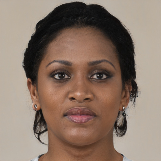 Joyful black young-adult female with medium  brown hair and brown eyes