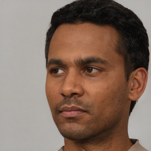 Neutral black young-adult male with short  black hair and brown eyes
